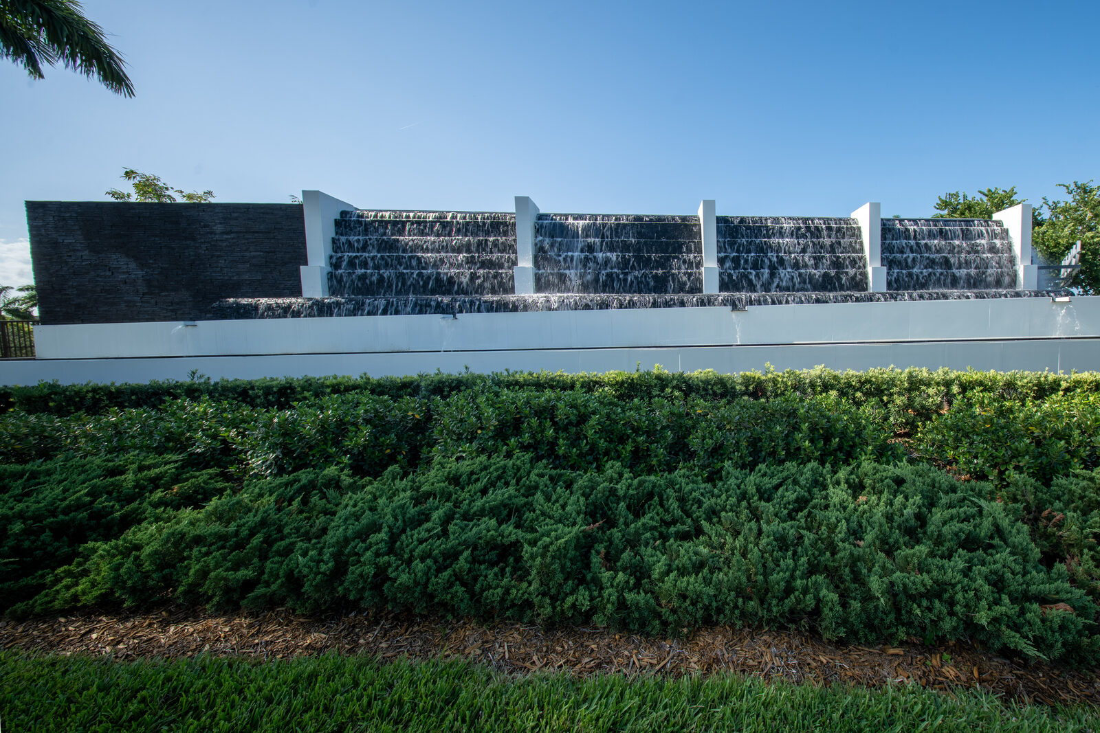 Restored commercial entrance water feature and landscaping at a gated community in Parkland, Florida