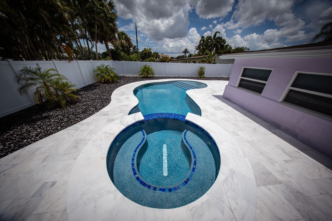 PebbleSheen Blue Surf pool finish on a custom pool and spa in Pompano Beach, Florida